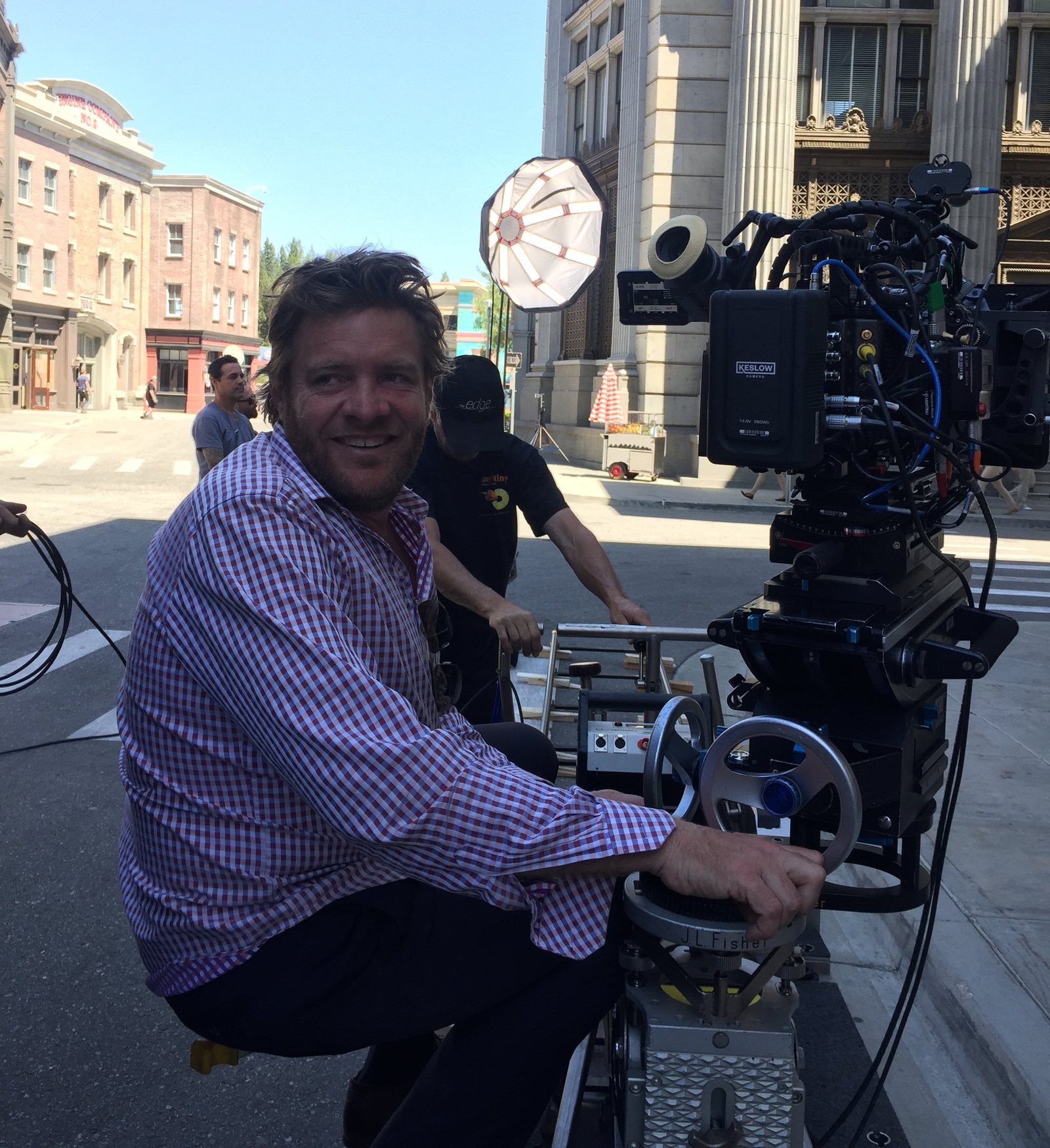 Tim Hudson behind a cinema camera on a backlot street