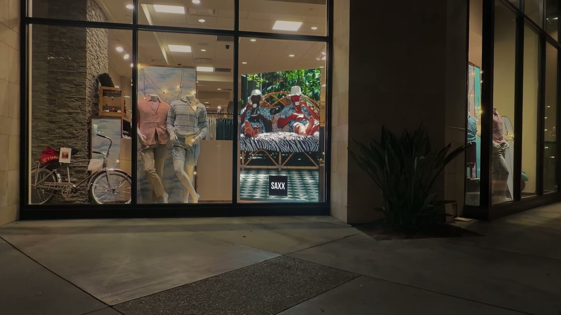 Storefront display showing SAXX content on a Hudson Pictures LED video wall
